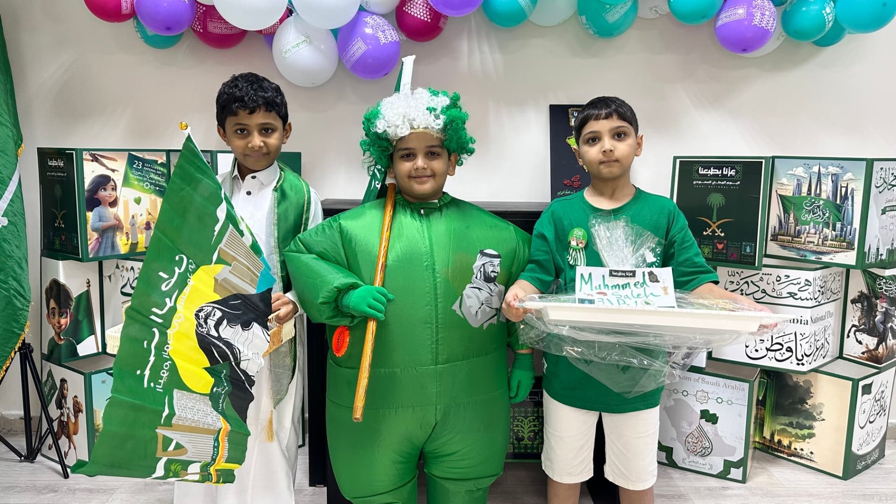 ARWA pupils in Saudi National Day costume holding the national flag