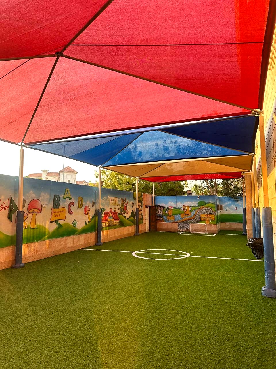 Shaded artificial-turf playground at the ARWA campus